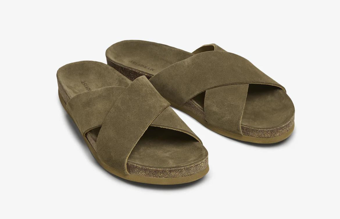 Green suede cross-over slip-on sandals angled pair view