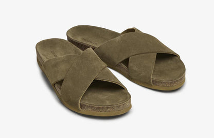 Green suede cross-over slip-on sandals angled pair view